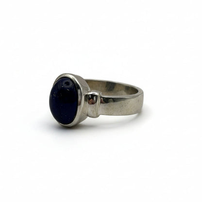 Silver ring with a lapiz lazuli gemstone on a gray background